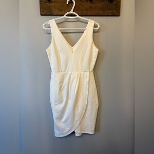 White Asymmetrical Mini Dress with a deep v neckline in size Medium